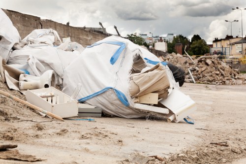 Construction site with waste materials being sorted for disposal in Carshalton